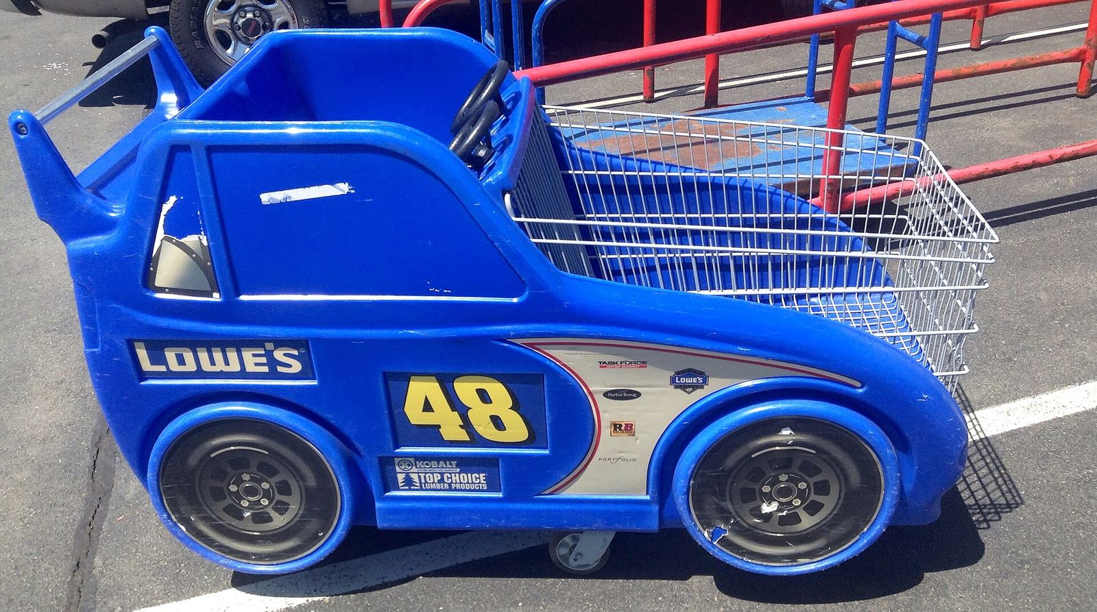 A blue Lowe's shopping cart shaped like the No. 48 race car