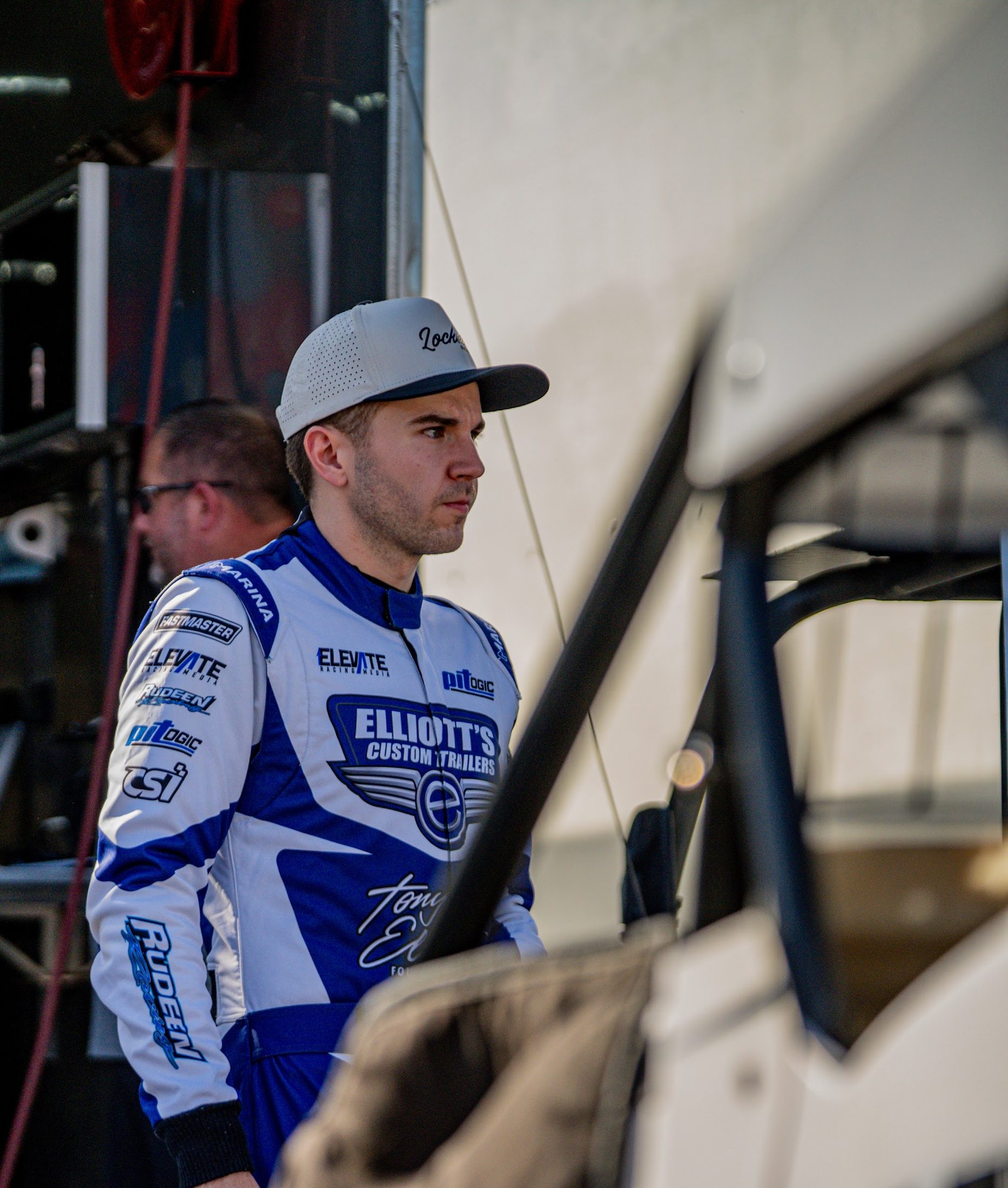 Driver in a firesuit waiting in the pits